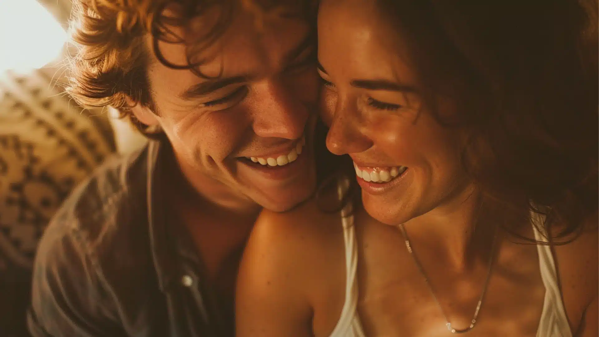 A close up of a happy couple laughing together.