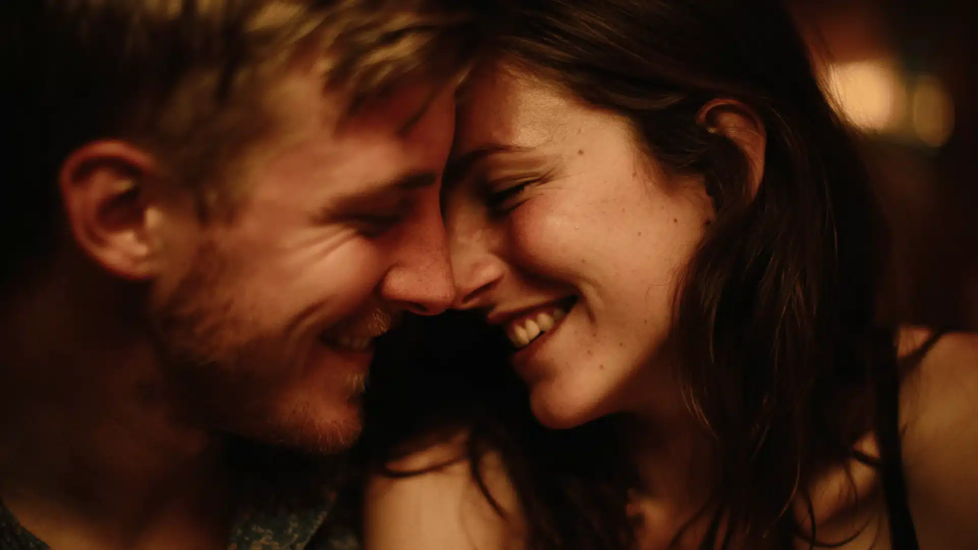 A man and woman are smiling together exuding joy and warmth in a friendly setting showcasing their connection and happiness.