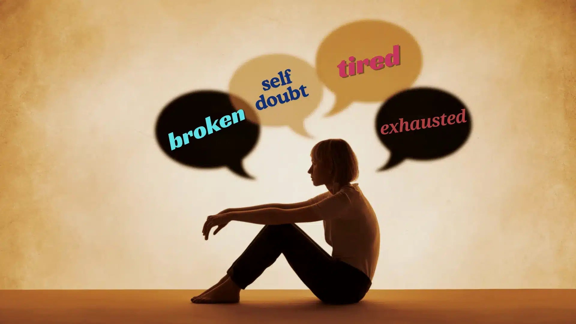 Woman sitting alone with blurred speech bubbles, showing confusion and mental overwhelm