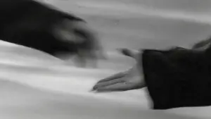 A monochrome photo depicting two hands reaching out, illustrating a gesture of support and human connection