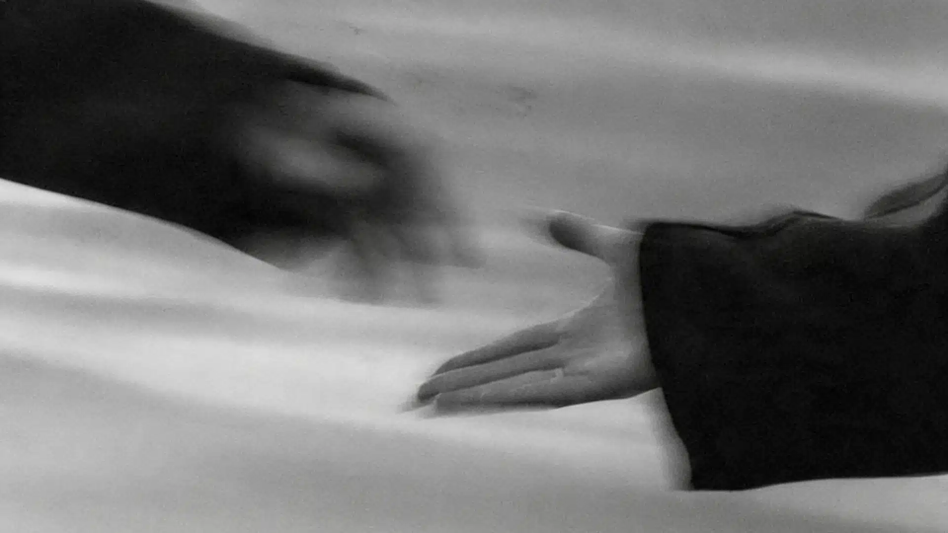 A monochrome photo depicting two hands reaching out, illustrating a gesture of support and human connection