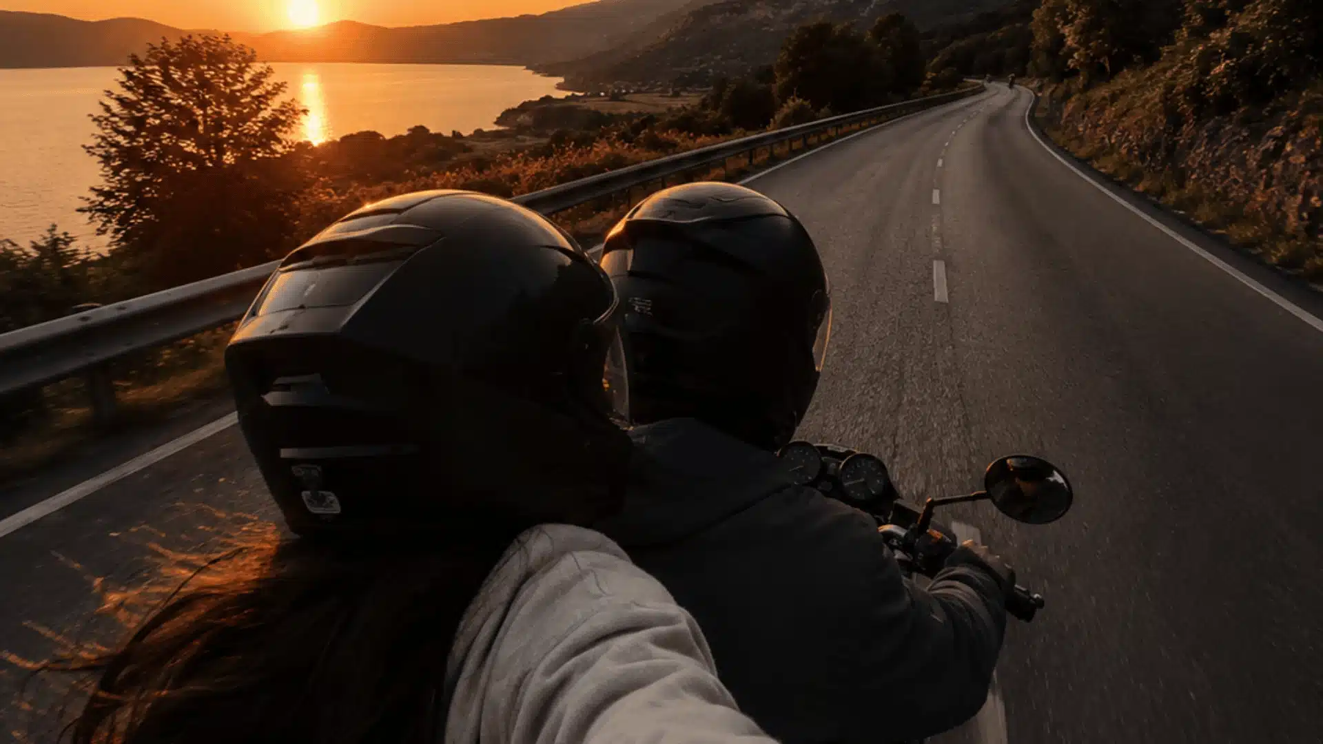 Romantic bike ride road trip at sunset along a scenic coastal highway with mountain views