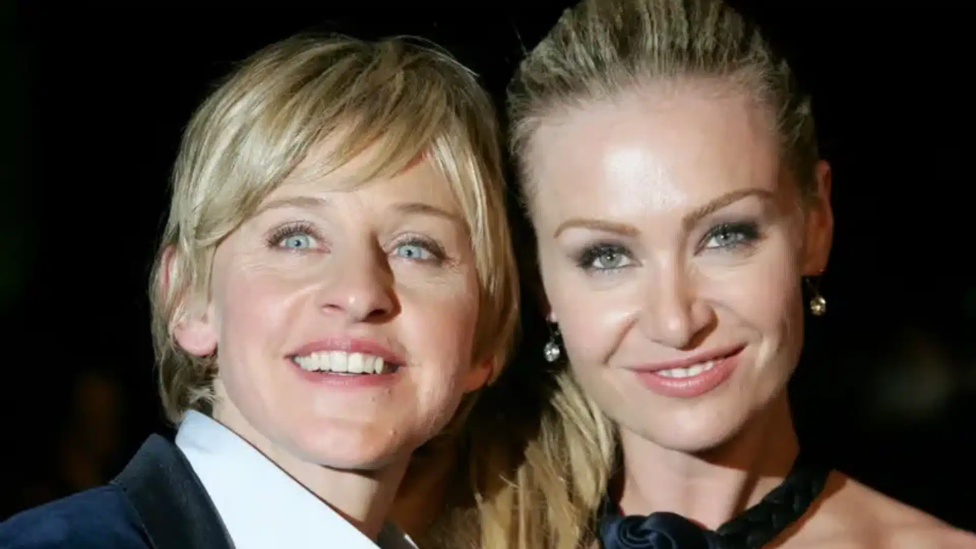 Close-up of Ellen DeGeneres and Portia de Rossi smiling together against a dark background