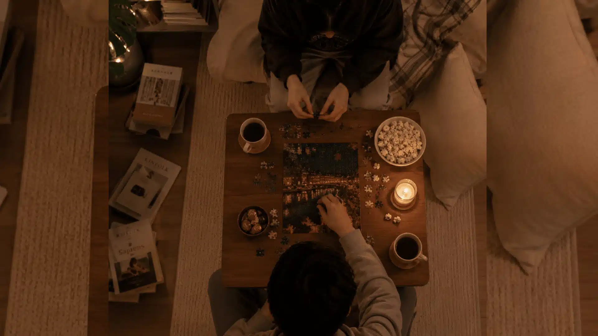 Cozy indoor date night with couple solving puzzle by candlelight in a warm relaxing apartment