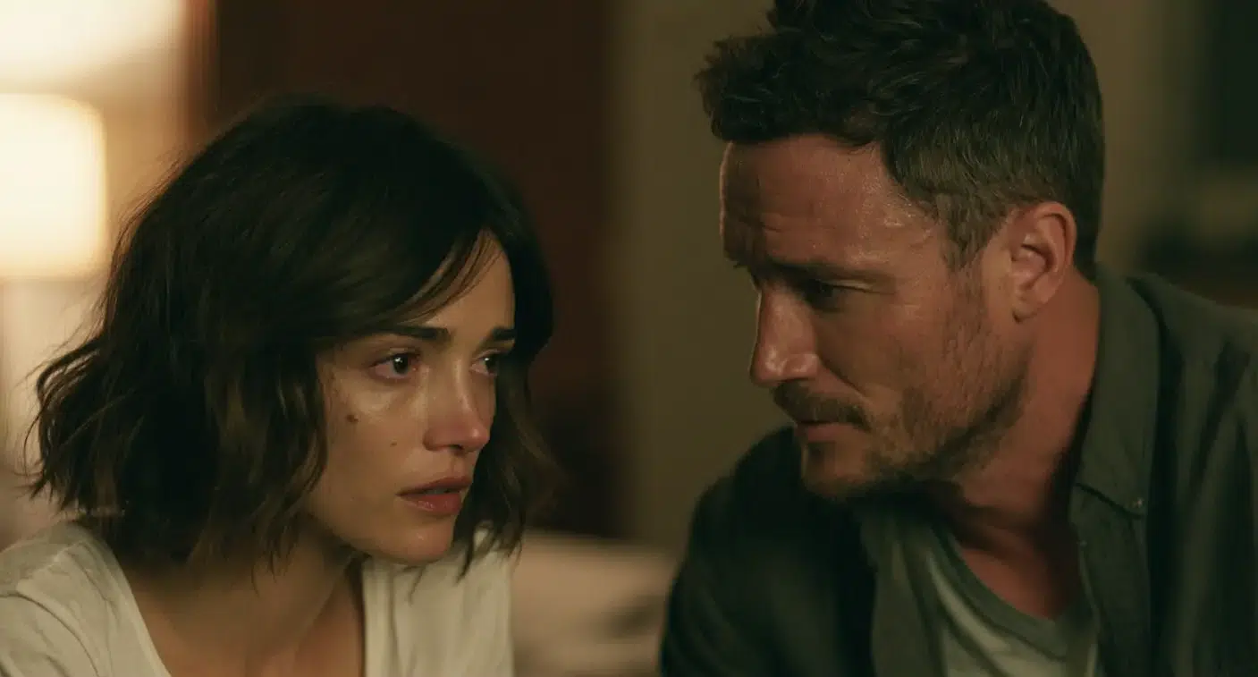 A man and woman sitting, woman seems to be sad and crying.