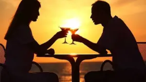 Couple enjoying a romantic dinner date at sunset while talking across the table representing healthy dating meaningful conversations and emotional connection