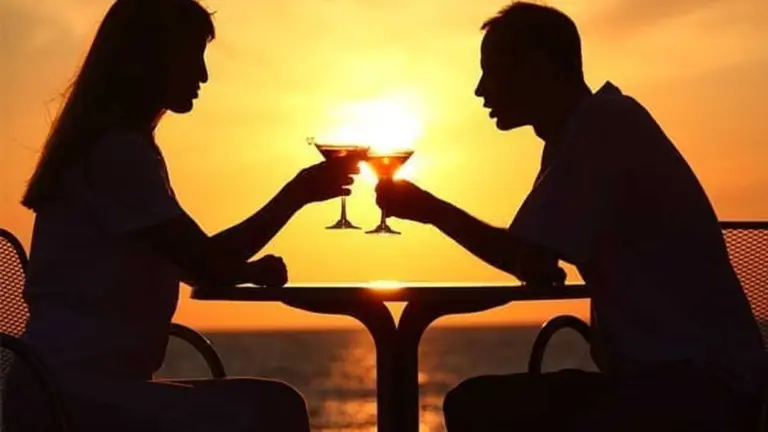 Couple enjoying a romantic dinner date at sunset while talking across the table representing healthy dating meaningful conversations and emotional connection