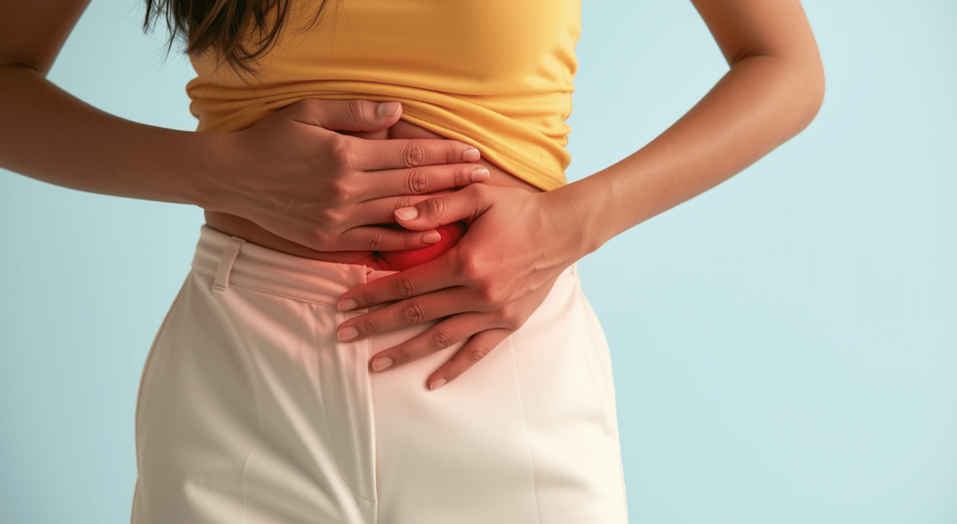 Person in a yellow shirt and white pants clutching their lower abdomen, with a red highlight indicating abdominal pain.