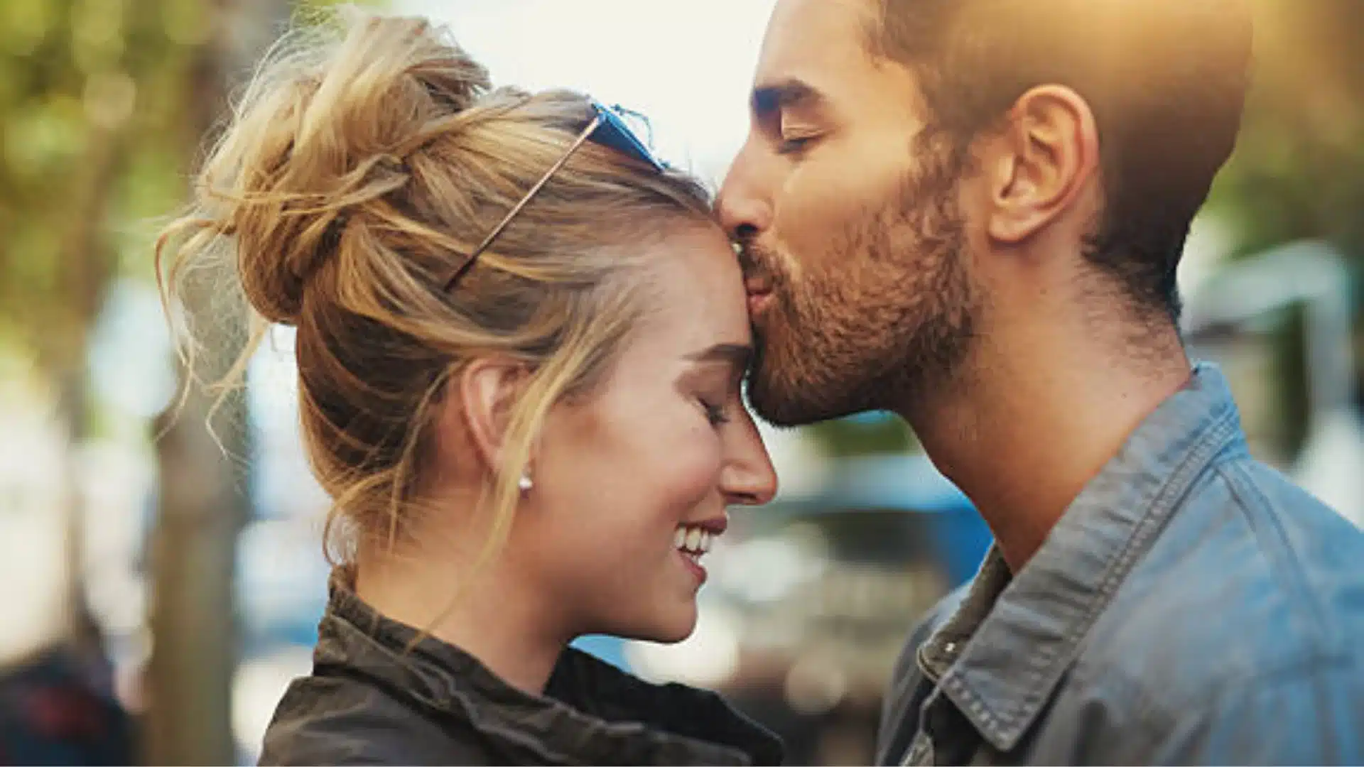 Loving couple sharing a gentle forehead kiss with warm smiles showing affection trust and emotional connection while demonstrating how to improve intimacy in a healthy relationship