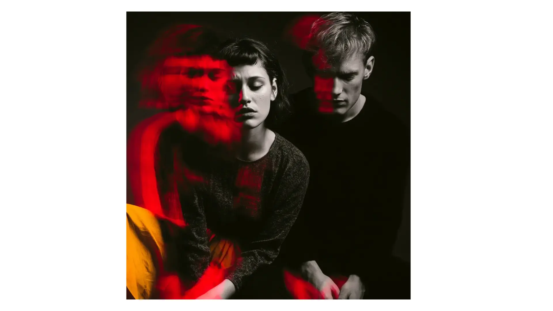 A man and woman are sitting together, red light, yellow and black aesthetic looking upset